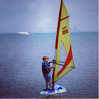 A young boy windsurfing